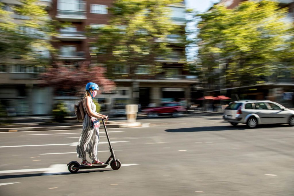 Girl In City Using EScooter